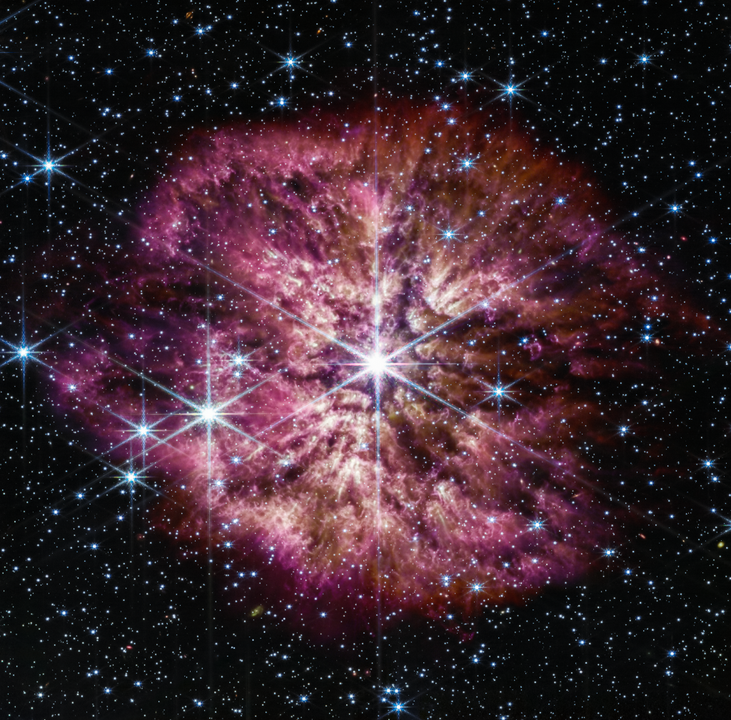 Um einen sehr hellen Stern mit sechs Lichtzacken ist ein violetter Nebel angeordnet.