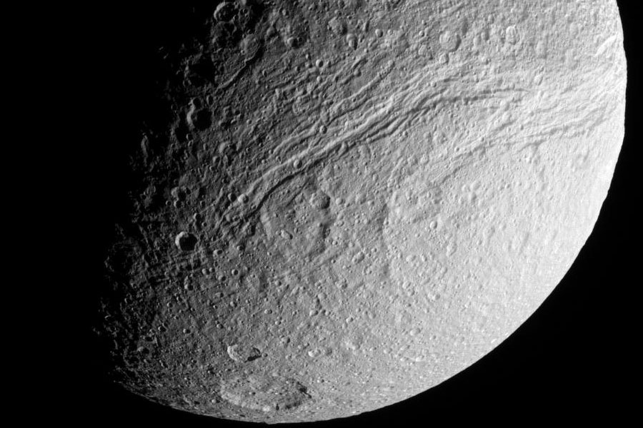 Das schwarz-weiße Bild zeigt den mit Kratern und Gräben überzogenen Saturnmond Tethys.
