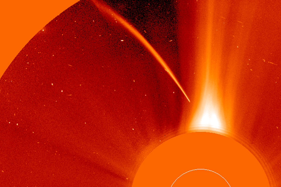 Das orangefarbene Bild zeigt, wie ein Komet in die Sonne fällt.