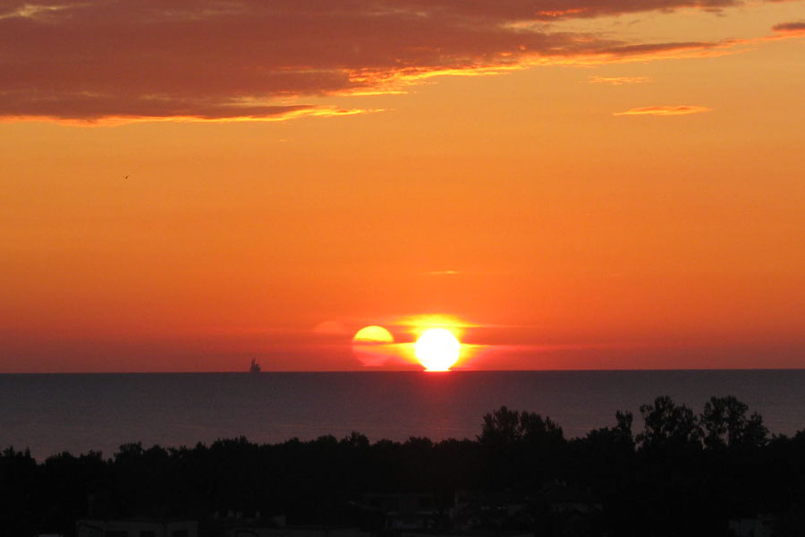 Bei diesem seltsamen Sonnenuntergang sind mehrere Abbildungen der Sonne zu sehen.