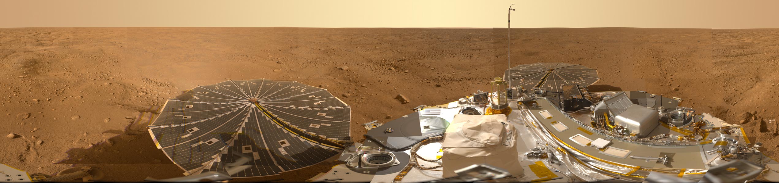Am unteren Bildrand ist die Landesonde Phoenix, dahinter die Marsoberfläche und oben die Marsatmosphäre.