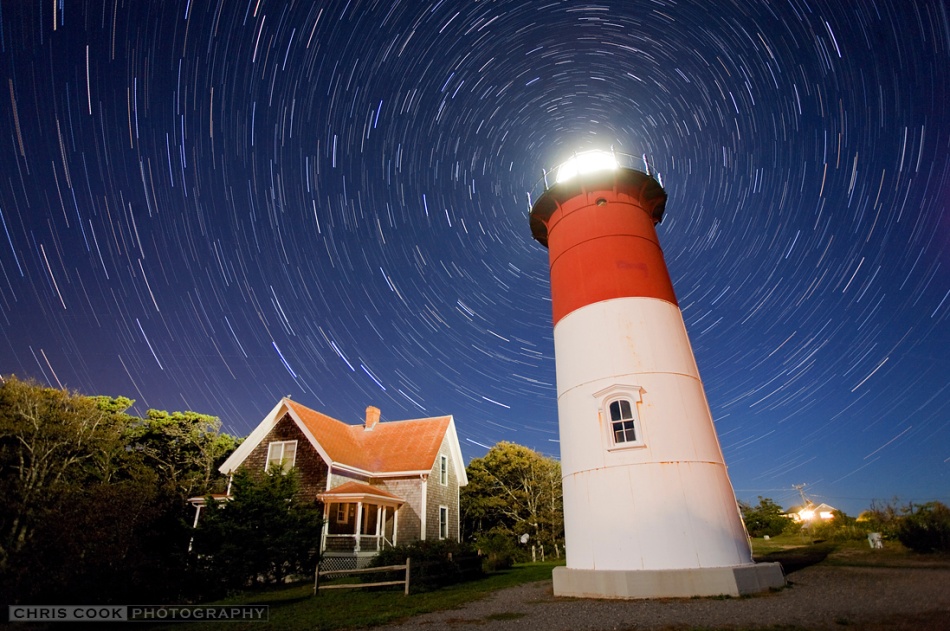 Hinter dem Leuchtturm Nauset Light in Eastham steht der Polarstern, um den die Sterne des Nordhimmels scheinbar rotieren und am Himmel Strichspuren ziehen.