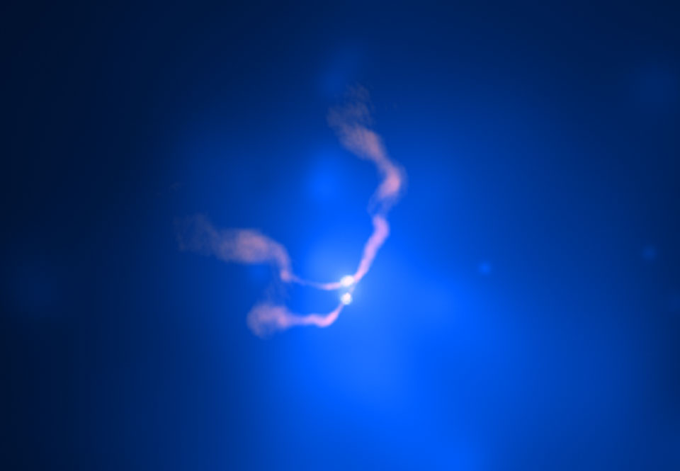 Mitten im Bild leuchtet ein blauer Nebel vor einem dunklen Hintergrund, darin zeichnen sich zwei sternartige Lichtquellen ab, von denen drei nebelartige rosarote Schlieren ausströmen.