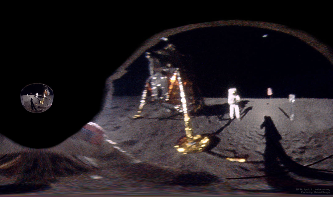 Das Bild ist eine Spiegelung in einem Visier, es zeigt das Mondlandemodul, einen Astronauten, zwei Experimente und den Schatten des Astronauten, der fotografiert.
